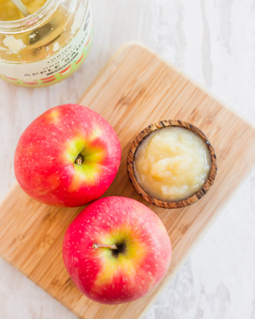 Honeycrisp apples and unsweetened applesauce in a wooden bowl.