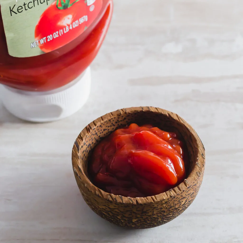 Ketchup in a small condiment bowl.