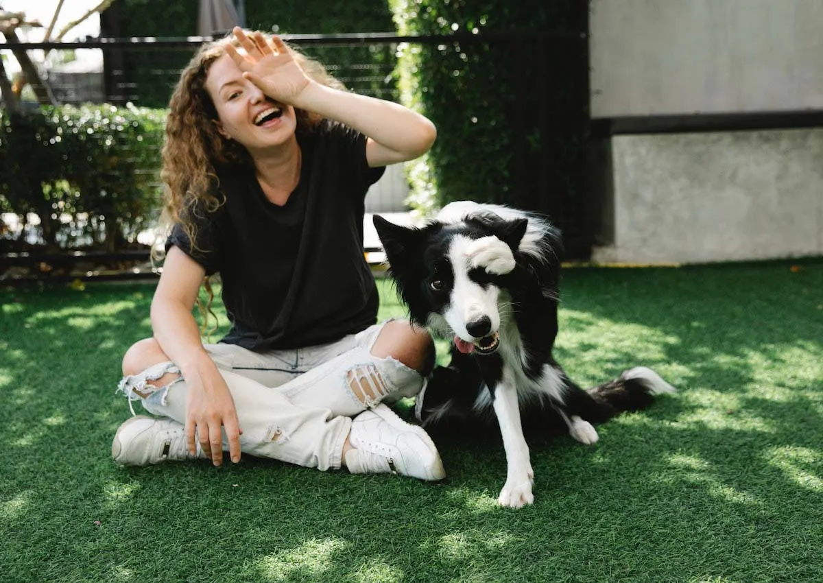 Dog and woman covering their eyes with their hand and paw.