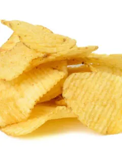 A pile of potato chips on a white background.