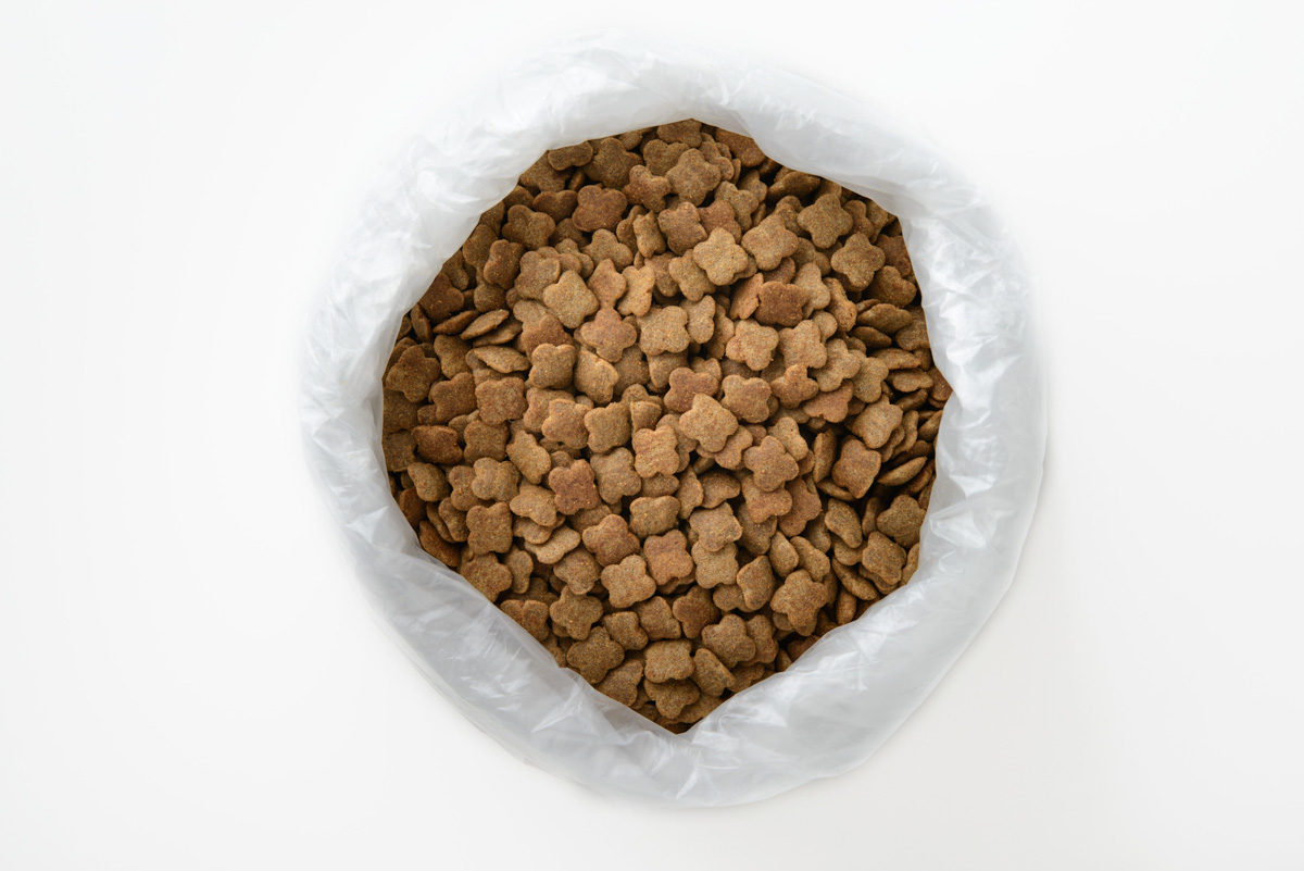 A bag of dog food on a white background.