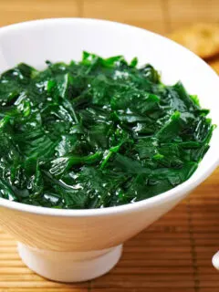 Traditional Japanese soup made of seaweed wakame in white bowl.